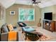 Bonus room with ceiling fan, large windows, comfortable furniture, and wall-mounted television at 1384 Independence Way, Marietta, GA 30062