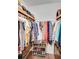 Walk-in closet featuring wooden shelves and rods for optimal storage of clothing and shoes at 1384 Independence Way, Marietta, GA 30062