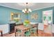 Charming dining room with rustic wood table, complemented by elegant decor and serene blue walls at 1384 Independence Way, Marietta, GA 30062
