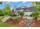 Back exterior featuring patio, stone landscaping, and stairs, blending indoor/outdoor living at 1384 Independence Way, Marietta, GA 30062