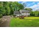 Beautiful two-story home with lush green lawn and surrounding trees, creating a peaceful setting at 1384 Independence Way, Marietta, GA 30062