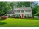 Charming two-story home featuring a bright red front door and a beautifully manicured lawn at 1384 Independence Way, Marietta, GA 30062