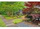 Charming front yard featuring lush landscaping and a walkway leading to the home's entrance at 1384 Independence Way, Marietta, GA 30062