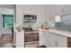 Well-equipped kitchen with stainless steel appliances, white cabinets, and a striking blue backsplash, perfect for culinary enthusiasts at 1384 Independence Way, Marietta, GA 30062