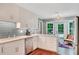 Bright kitchen with white cabinets, stainless steel appliances, and a charming breakfast nook with a view to the backyard at 1384 Independence Way, Marietta, GA 30062
