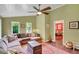 Cozy living room boasts a ceiling fan, many windows providing natural light and a view into the adjacent room at 1384 Independence Way, Marietta, GA 30062