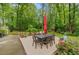 Charming patio area with dining set and vibrant flowers, perfect for outdoor entertaining at 1384 Independence Way, Marietta, GA 30062
