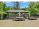 Outdoor community patio with dining sets and tables under a covered pergola at 1384 Independence Way, Marietta, GA 30062