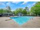 Community pool with a diving board, a covered area, and plenty of chairs for relaxation by the water at 1384 Independence Way, Marietta, GA 30062