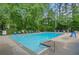 Outdoor community pool with lounge chairs surrounded by trees, creating a relaxing ambiance at 1384 Independence Way, Marietta, GA 30062