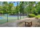 Fenced tennis court with outdoor seating, providing a great amenity for residents at 1384 Independence Way, Marietta, GA 30062