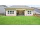 Large backyard featuring a covered patio, lush lawn, and fenced perimeter at 169 Hickory Bluffs Pkwy, Canton, GA 30114