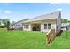 View of the backyard with lush grass, a covered patio, and perimeter fencing at 169 Hickory Bluffs Pkwy, Canton, GA 30114