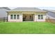 Well-maintained backyard with lush green grass and a covered patio, ideal for relaxation at 169 Hickory Bluffs Pkwy, Canton, GA 30114