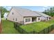 Expansive backyard featuring lush green grass, a covered patio, and fenced yard at 169 Hickory Bluffs Pkwy, Canton, GA 30114
