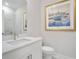 Bright bathroom featuring a modern vanity with white countertop and nautical themed wall art at 169 Hickory Bluffs Pkwy, Canton, GA 30114