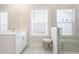 Bright bathroom with a single vanity, marble floors, a mirror and a glass enclosed shower at 169 Hickory Bluffs Pkwy, Canton, GA 30114