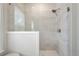 Bathroom featuring stand-up shower with marbled tile and glass door at 169 Hickory Bluffs Pkwy, Canton, GA 30114