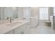 Bright bathroom features double vanity, white marble floors, and glass enclosed shower at 169 Hickory Bluffs Pkwy, Canton, GA 30114