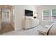 Brightly lit bedroom with a hallway entryway, a dresser on one side and a view of the trees outside at 169 Hickory Bluffs Pkwy, Canton, GA 30114