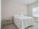Cozy bedroom featuring a white comforter, window with blinds, and gray carpet at 169 Hickory Bluffs Pkwy, Canton, GA 30114