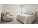 Neutral bedroom showcasing chair, plush throw pillows, patterned coverlet, and gray carpet at 169 Hickory Bluffs Pkwy, Canton, GA 30114