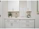 All-white built-in cabinetry, modern hardware, countertop decor, and gray walls at 169 Hickory Bluffs Pkwy, Canton, GA 30114