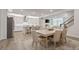 Open-concept kitchen and dining area with stainless steel appliances and comfortable seating for six at 169 Hickory Bluffs Pkwy, Canton, GA 30114