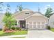 Charming single Gathering home features a 2 car garage, stone accents, manicured lawn, and inviting curb appeal at 169 Hickory Bluffs Pkwy, Canton, GA 30114