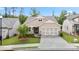 Well maintained single Gathering home with a 2 car garage, stone accents, manicured lawn, and inviting curb appeal at 169 Hickory Bluffs Pkwy, Canton, GA 30114
