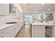 Well-lit kitchen with stainless appliances, white cabinets, island and open floor plan at 169 Hickory Bluffs Pkwy, Canton, GA 30114
