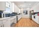 Modern kitchen featuring white cabinets, wood flooring, stainless appliances, and blue backsplash at 169 Hickory Bluffs Pkwy, Canton, GA 30114