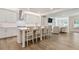 Open-concept kitchen with bar seating, stainless appliances, and access to the living room at 169 Hickory Bluffs Pkwy, Canton, GA 30114