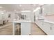 Bright, open kitchen boasts white cabinets, stainless steel appliances, and a large island with seating at 169 Hickory Bluffs Pkwy, Canton, GA 30114