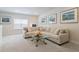 Comfortable living room showcasing a cream sofa, glass table, and sailboat artwork at 169 Hickory Bluffs Pkwy, Canton, GA 30114