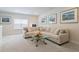 Bright living room featuring a plush sectional sofa and a glass coffee table, creating a comfortable and inviting space at 169 Hickory Bluffs Pkwy, Canton, GA 30114