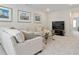 Inviting living room with cozy furniture, ship artwork and natural light creating a comfortable and stylish atmosphere at 169 Hickory Bluffs Pkwy, Canton, GA 30114