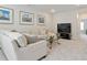 Comfortable living room showcasing a cream sofa, glass table, and sailboat artwork at 169 Hickory Bluffs Pkwy, Canton, GA 30114