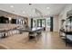 Open lounge area with large table for dining, multiple TVs, and brick accent wall at 169 Hickory Bluffs Pkwy, Canton, GA 30114