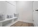 Mudroom with coat hooks, bench seating, storage cubbies, and wood-look flooring at 169 Hickory Bluffs Pkwy, Canton, GA 30114