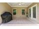 Covered outdoor patio area with ceiling fan, grill, and easy access to the backyard at 169 Hickory Bluffs Pkwy, Canton, GA 30114
