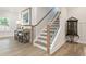 Staircase with hardwood steps and a decorative side table and lamp at 169 Hickory Bluffs Pkwy, Canton, GA 30114