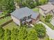 Aerial view of a two-story home with manicured landscaping and a private backyard at 2430 Tack Hill Ct, Dacula, GA 30019