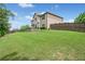 Expansive backyard with lush green grass, tiered landscaping, and mature trees at 2430 Tack Hill Ct, Dacula, GA 30019