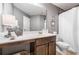 Well-lit bathroom features a white vanity, framed mirror, and shower-tub combination at 2430 Tack Hill Ct, Dacula, GA 30019