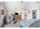 Inviting bedroom features plush armchair and ottoman, with soft carpet and ensuite access at 2430 Tack Hill Ct, Dacula, GA 30019