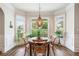 Cozy breakfast nook with a round table, wooden chairs, and large windows at 2430 Tack Hill Ct, Dacula, GA 30019