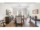 Formal dining room with wood floors, coffered ceilings, and elegant furnishings at 2430 Tack Hill Ct, Dacula, GA 30019