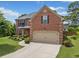Beautiful two-story brick home with a well-manicured lawn and two car garage at 2430 Tack Hill Ct, Dacula, GA 30019