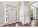 Inviting foyer with hardwood floors, white trim, and a sidelight window at 2430 Tack Hill Ct, Dacula, GA 30019